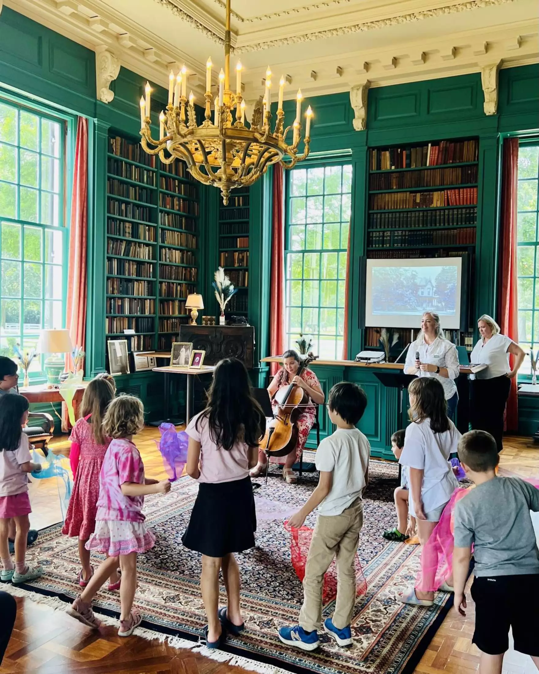 Cecilia Huerta-Lauf playing cello with Shirley Harmon narrating