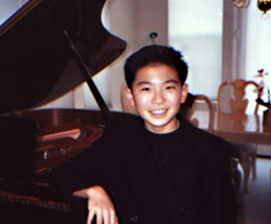 A young Sebastian Chang poses at the piano